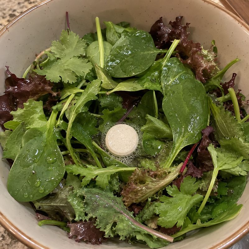 Pearl tablet cleaning leafy salad greens in a bowl